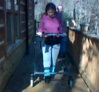 Don't Look Back. Shelly now walks a mile three days a week using the gait trainer shown here.